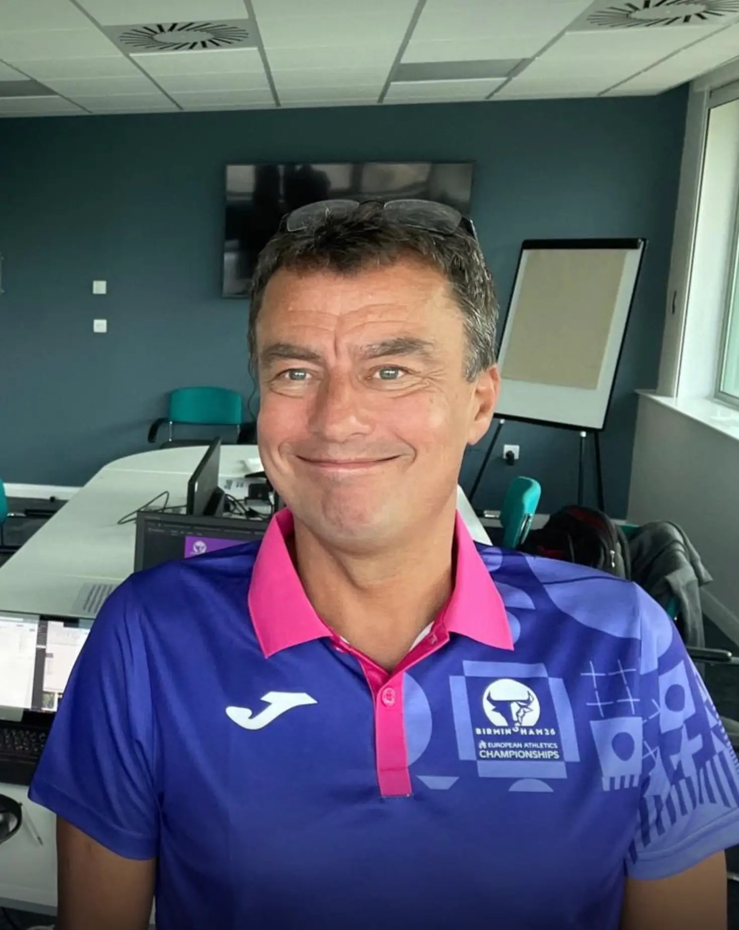 Kevin Nash, events director on the London Marathon working alongside Mint Command wearing a purple polo shirt in a control room
